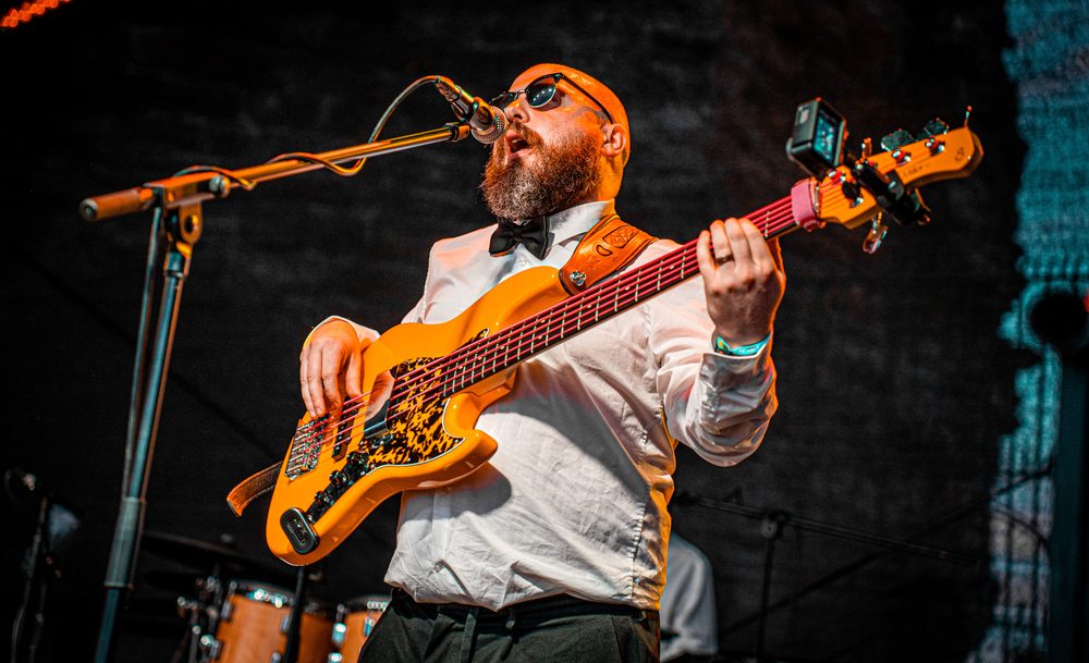 Reuben singing and playing bass
